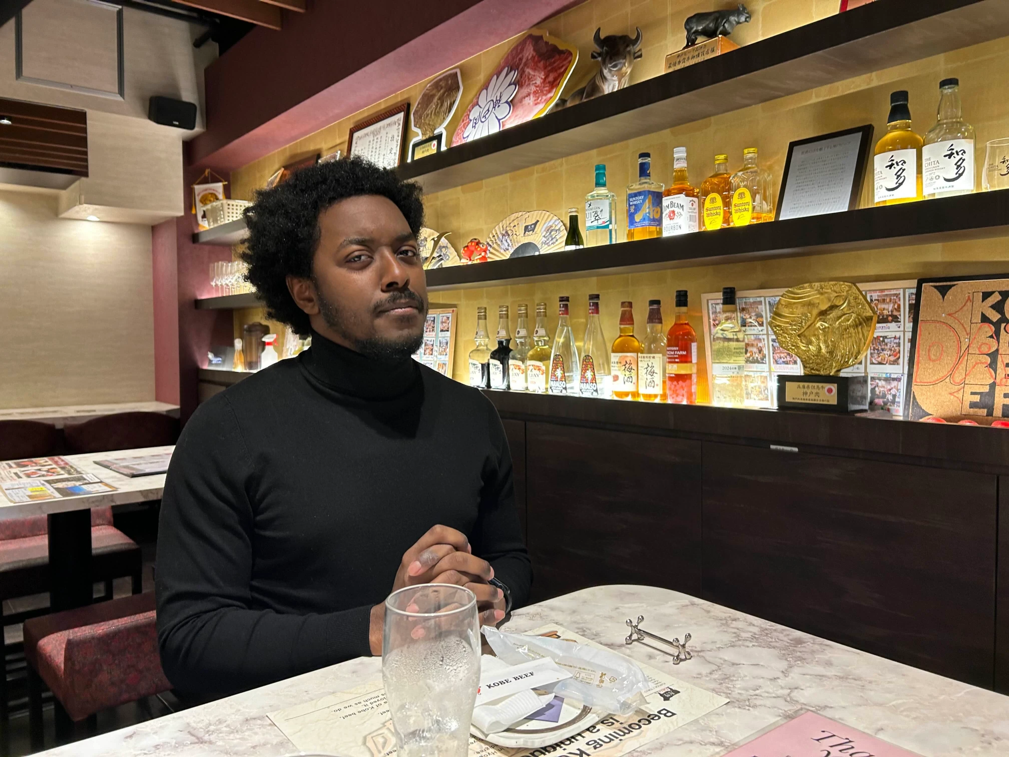 An immaculate photograph of the site author, Andre B. Dixon, aura-maxxing in a black turtleneck.
